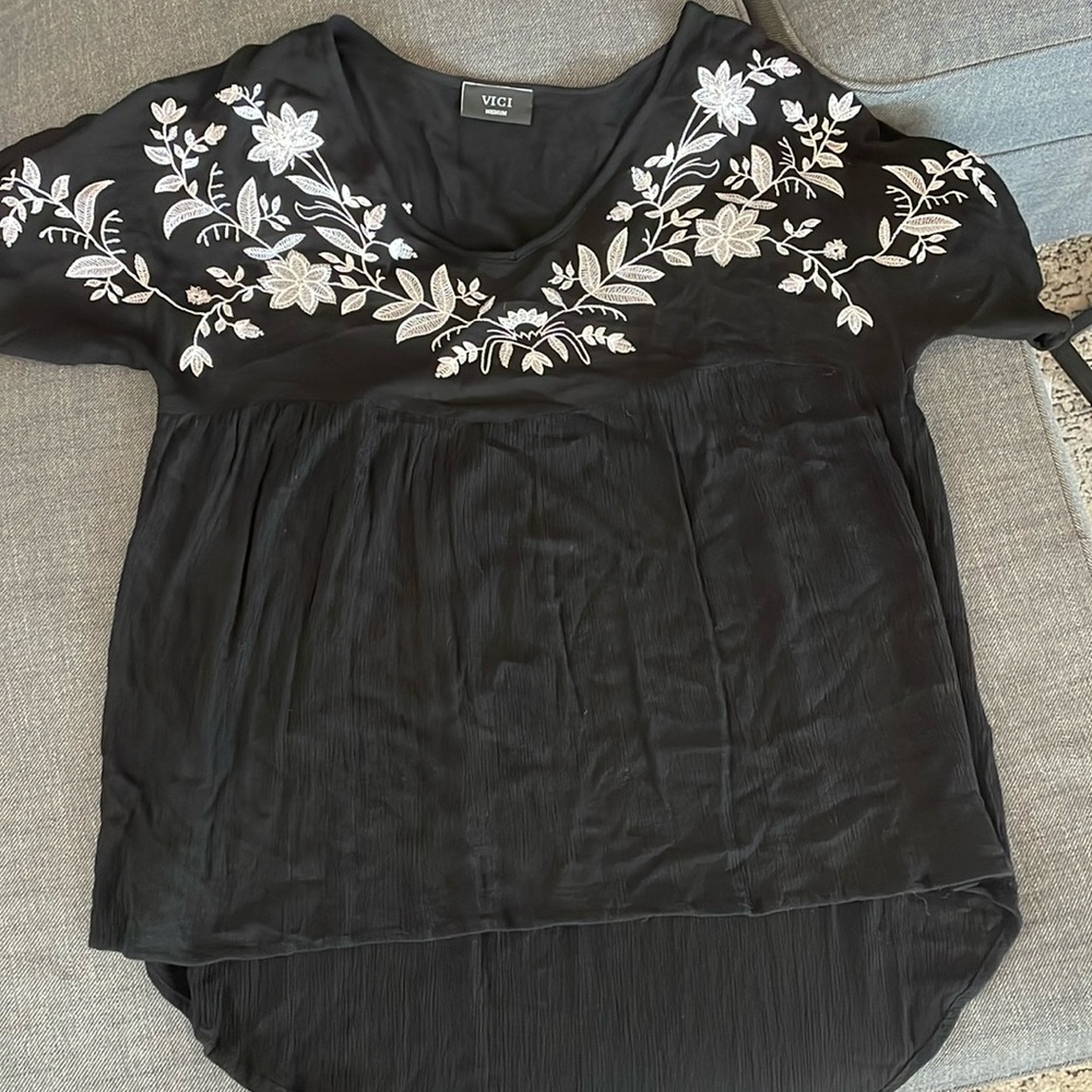 Black tunic shirt, v neck with whiteish silver detailing on front and back